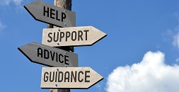 A sign post with the signs, Help, Support, Advice, Guidance posted on it